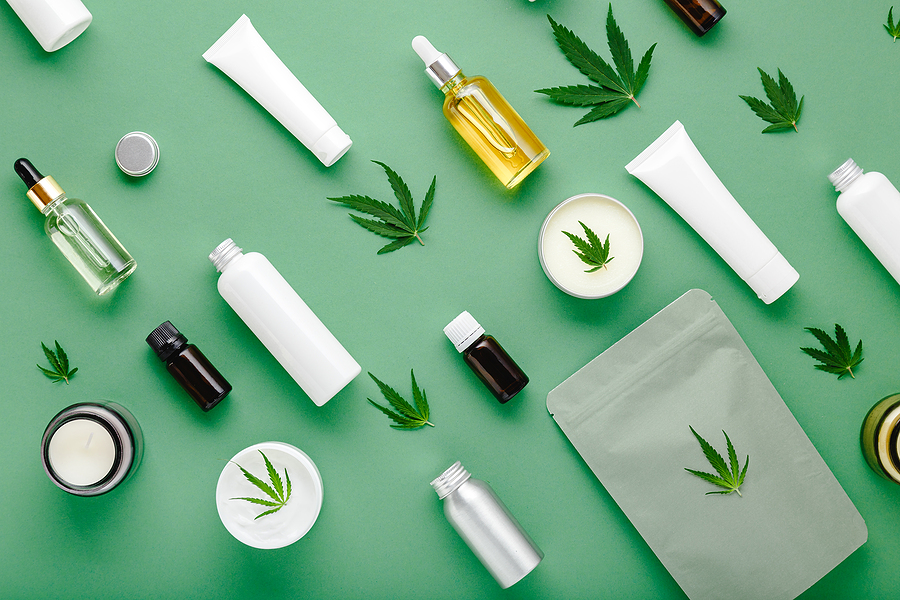 Hemp cbd oil serum in glass dropper bottle with cannabis leaves, Moisturizing cream, Serum, lotion, essential oil. Cannabis leaf with skincare cosmetic product Flat lay pattern on green background